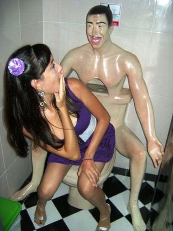 A woman is sitting on a toilet with a statue of a man, pondering her decision to date him. (part 1)