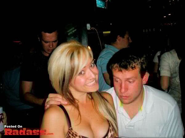 A couple posing for a picture in a club.