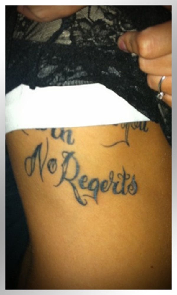 A woman with a stomach tattoo that will make you happy.