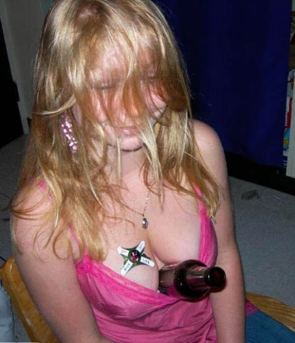 A girl sitting on a chair with a bottle in her mouth, displaying the keyword