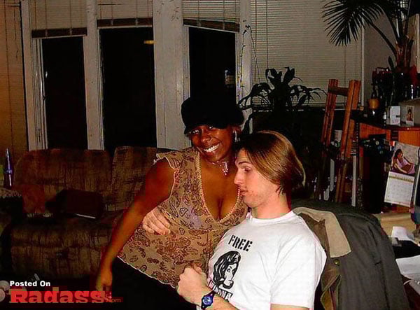 A couple posing for a picture in a living room.