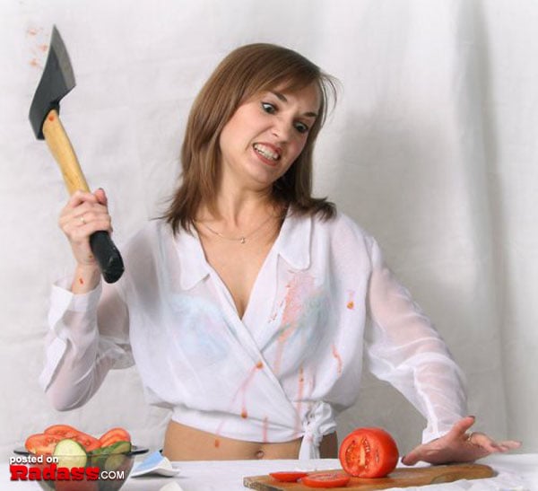 A woman wielding an ax with a fierce expression.