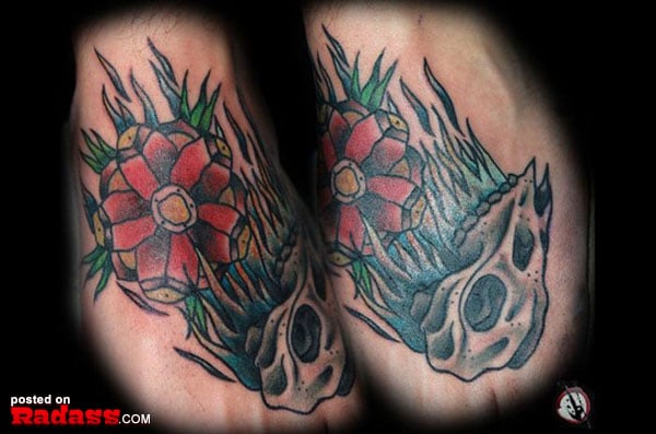 A woman in a blue dress posing next to a magazine cover featuring pop stars of the 90's and what they look like today.