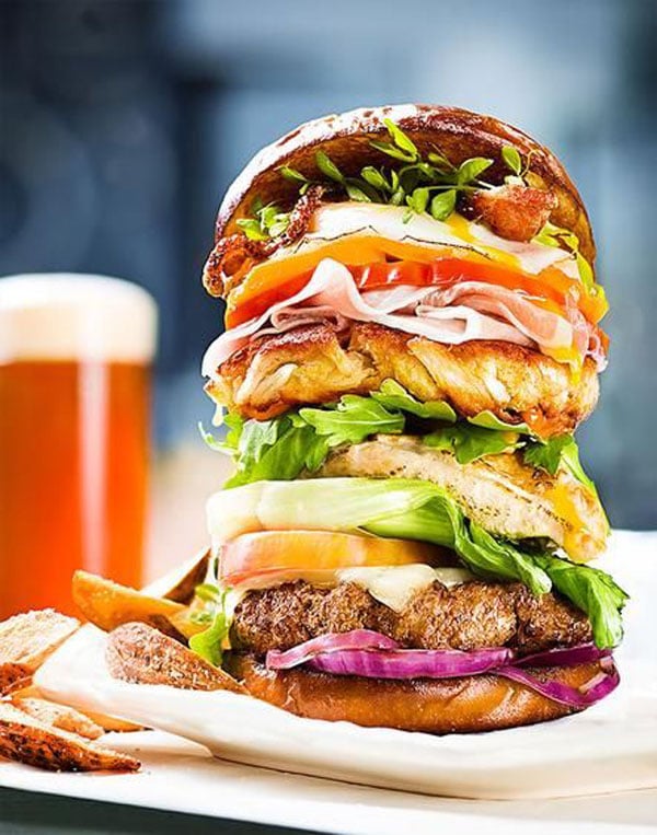 An awesome visual suggestion of a large burger on a plate.