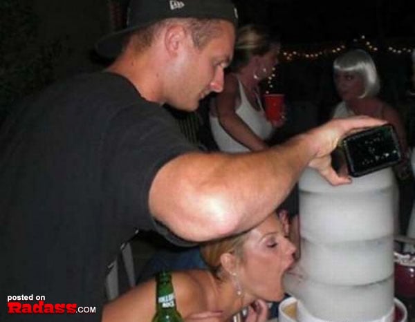A man capturing an ice sculpture at a party.