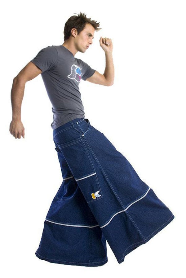 A man in a skirt is jumping up and down.