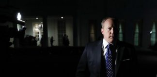 Sean Spicer reportedly hid in the White House bushes to avoid reporters standing in front of a white house.
