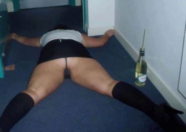 A woman lounging on the floor with a bottle of wine, pondering over the phrase