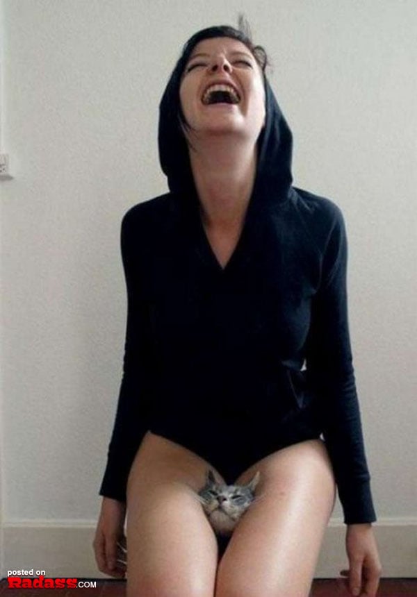 A woman sitting on the floor with a cat on her thigh, questioning