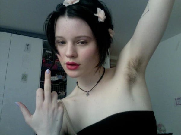 A girl with long hair and a flower on her arm, making her an ideal candidate for dating.