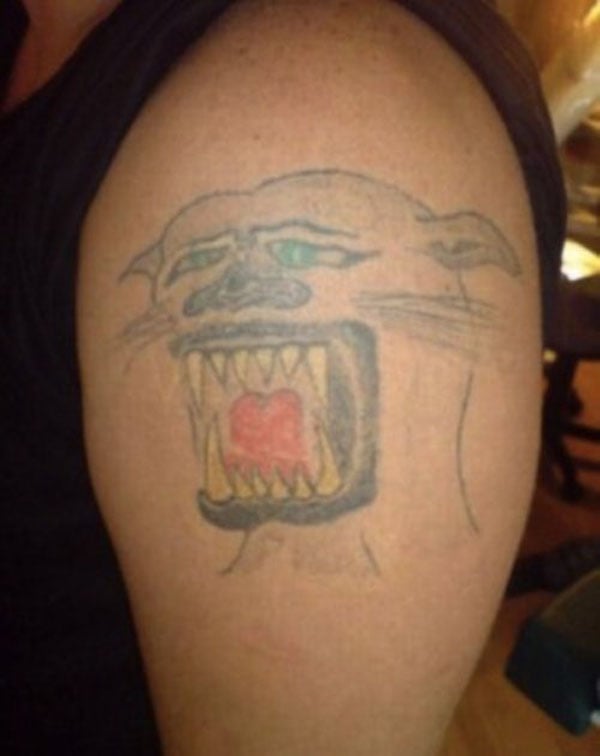 A man with a tiger tattoo on his arm to make you feel better about your life.