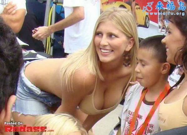 A woman in a bikini and shorts posing for a picture catches attention.