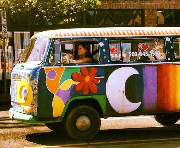 A vibrant dubs bus is cruising along the street.