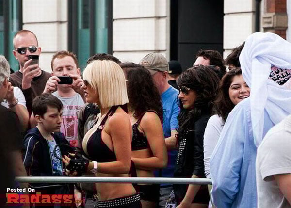 A woman in a bikini captivating a crowd.