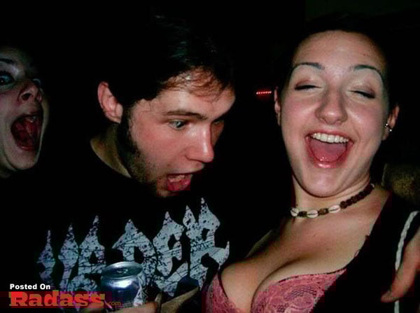 A man and a woman posing for a picture at a party.