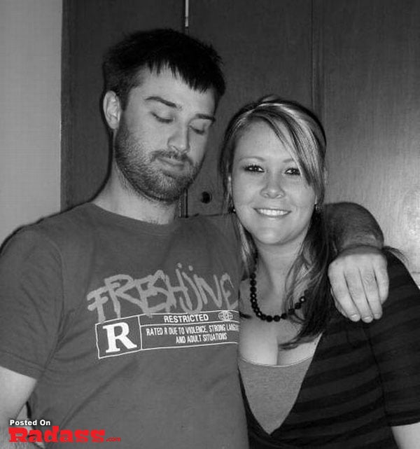 Black and white photo of a man and woman posing for a photo that makes you say