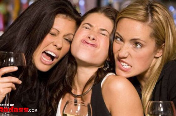 Three women are laughing while holding glasses of wine, jokingly saying "I Would Date You But…