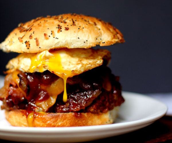 A delectable 2022 burger featuring a perfectly placed egg on top.