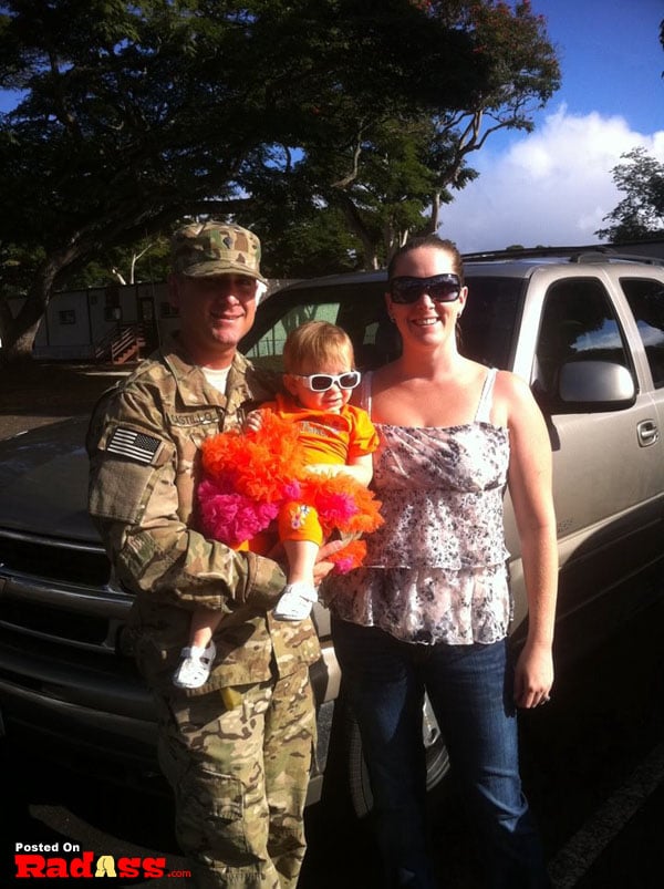 A woman and a child posing for a picture in front of an American truck, igniting gratitude and appreciation.