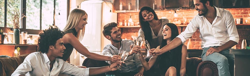 A group of friends enjoying drinks in a bar while practicing Drinking Etiquette.