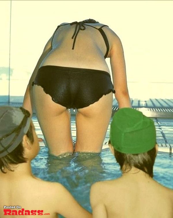 A woman in a bikini and a boy in a swimsuit at the beach.