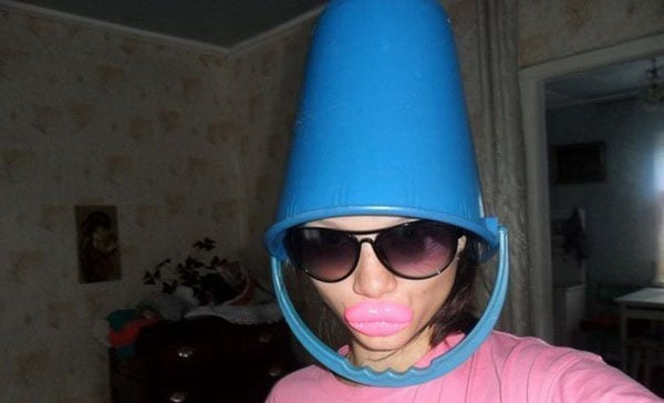 A stylish woman wearing sunglasses and a trendy blue bucket hat.