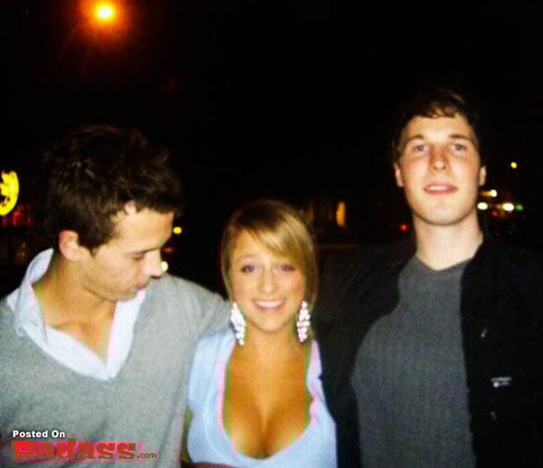 Three people standing next to each other at night.