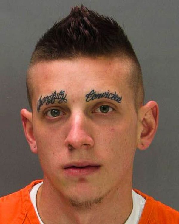 A man with comforting face tattoos.