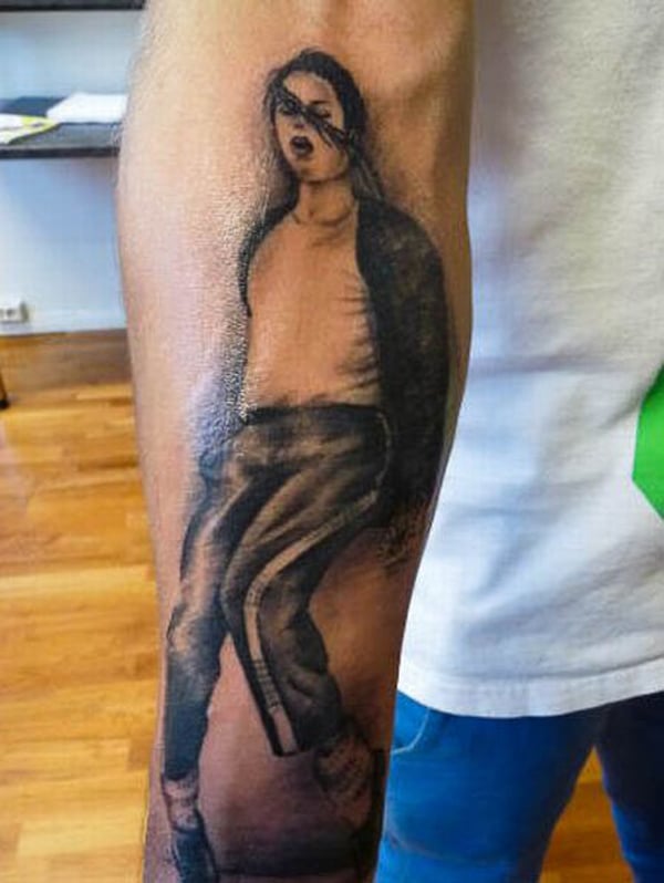 A forearm tattoo featuring Michael Jackson to uplift your life.