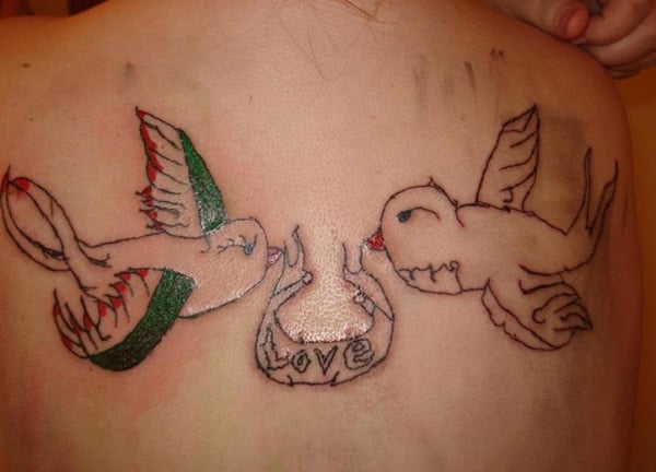 A woman with a regrettable tattoo of two birds on her back.