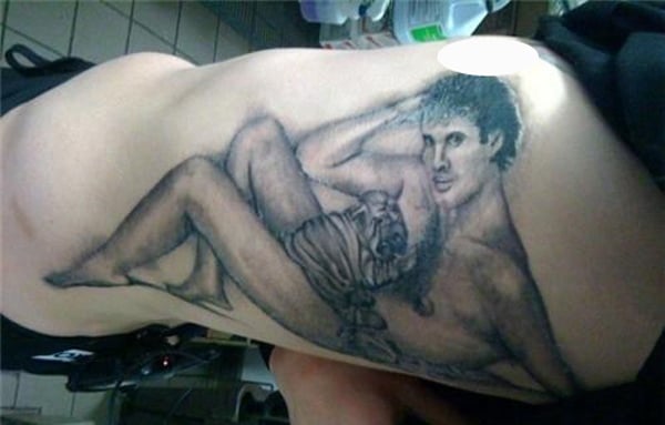 A woman displays a lifetime reminder of a regrettable decision through her permanent back tattoo.