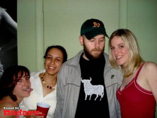A group of people posing for a picture in a bar.