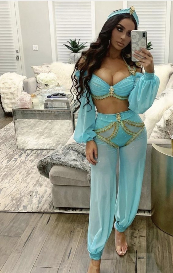 A woman is taking a selfie in a blue outfit showcasing RadAss uniqueness.