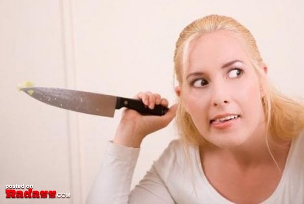 A woman is playfully holding a knife in front of her face, adding an element of danger to the phrase