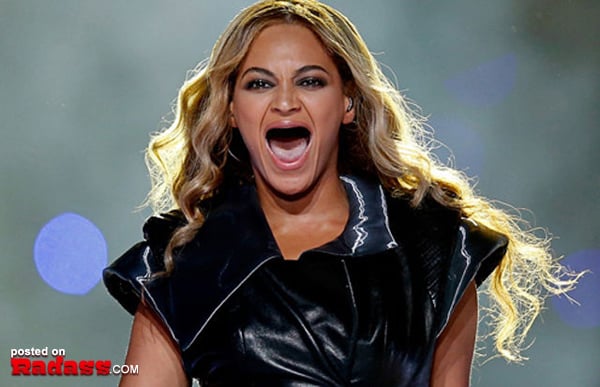 Toothless woman lounging on a bed with her mouth open.