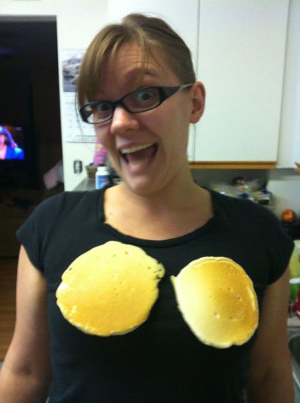 A woman wearing a shirt with pancakes on it that says,
