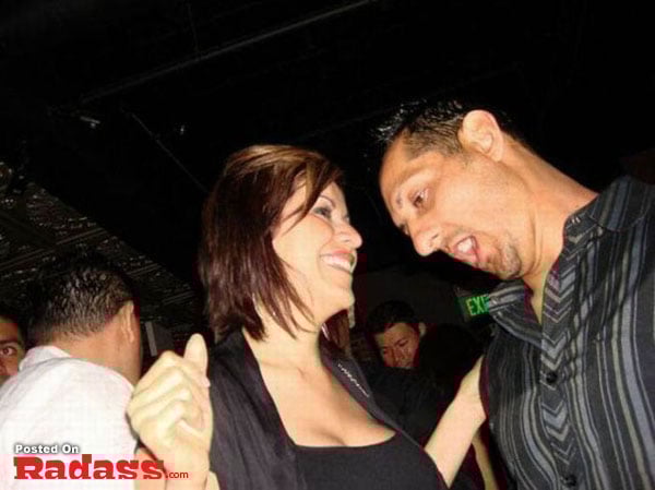 A man and woman standing next to each other at a nightclub, exploring the widespread popularity of nightclubs.