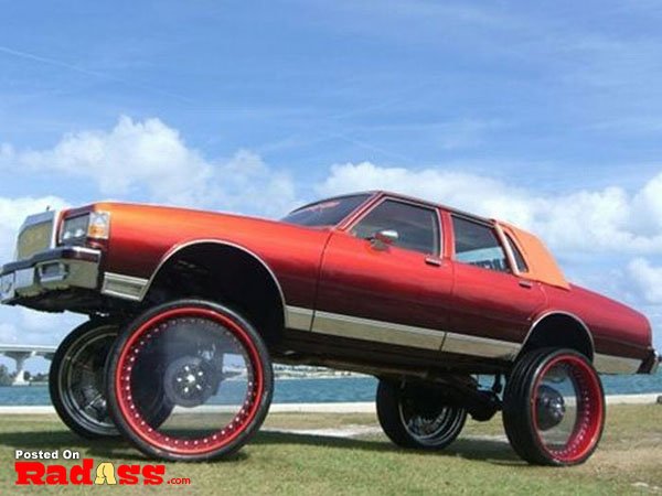 A bold red car with oversized wheels.