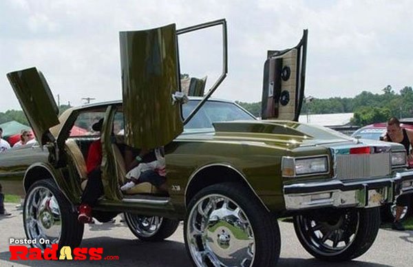 A green car with an open door.