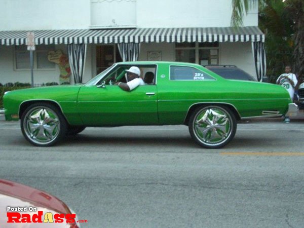 Green Chevrolet El Camino on rims, turning heads.