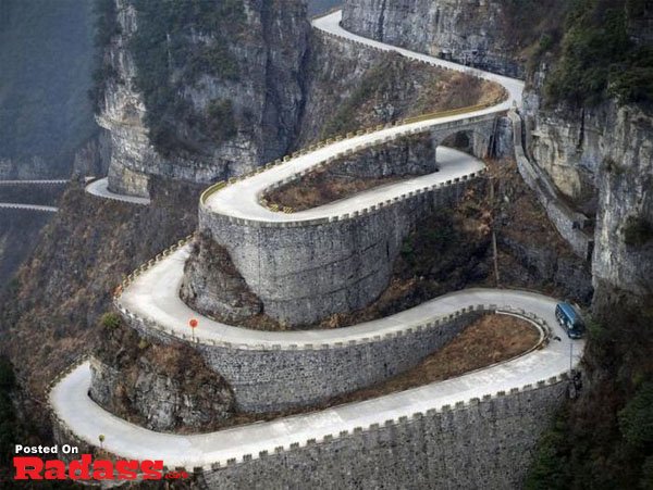 A car is driving down a winding road in China. (No changes made)