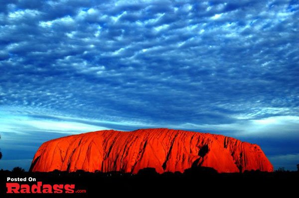 Uluru at sunset with breathtaking clouds.