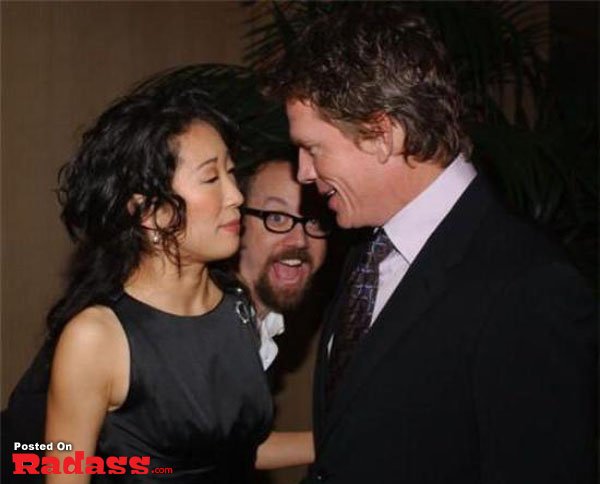 A man and woman photobombing each other at an event.