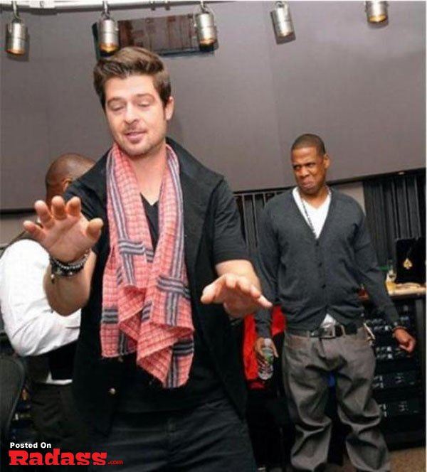 Two men in a recording studio, photobombing celebrity style.