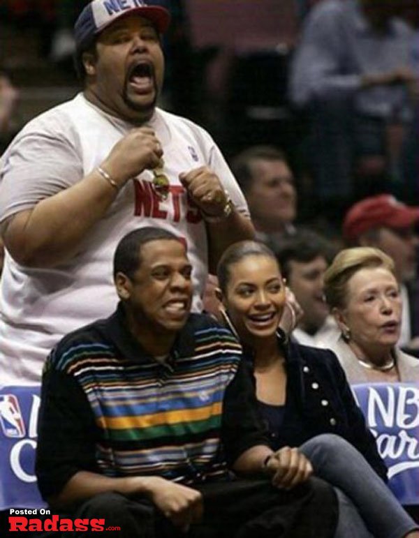 A man and woman photobombing each other at a basketball game.