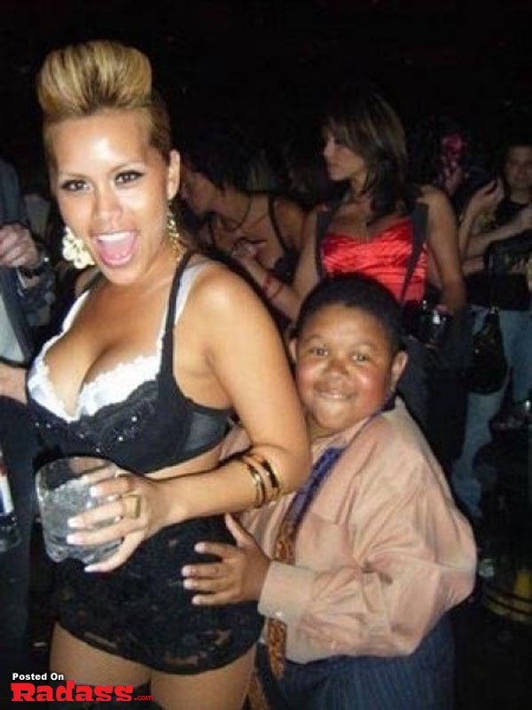 A woman in a bikini photobombs a boy at a party.