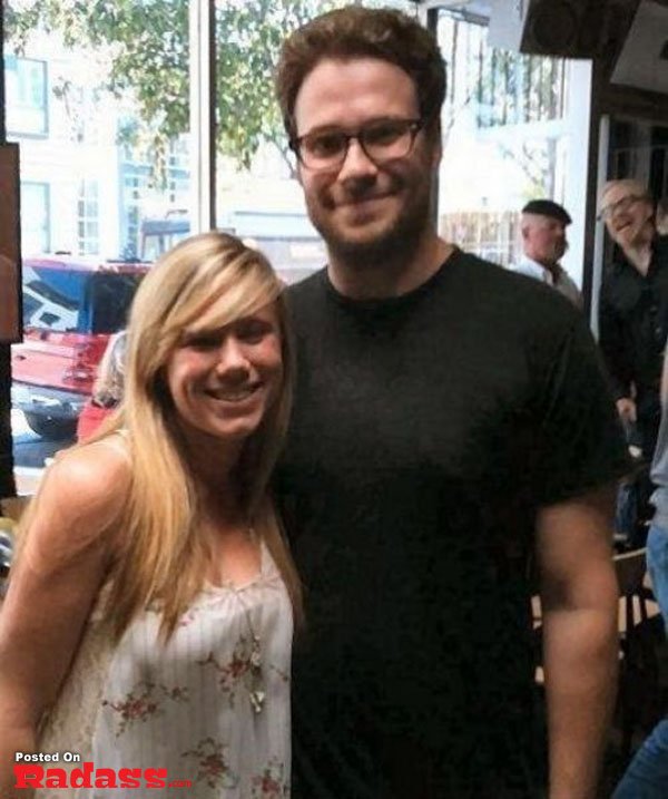 A man and a woman photobombing celebrity style while posing for a picture in a restaurant.