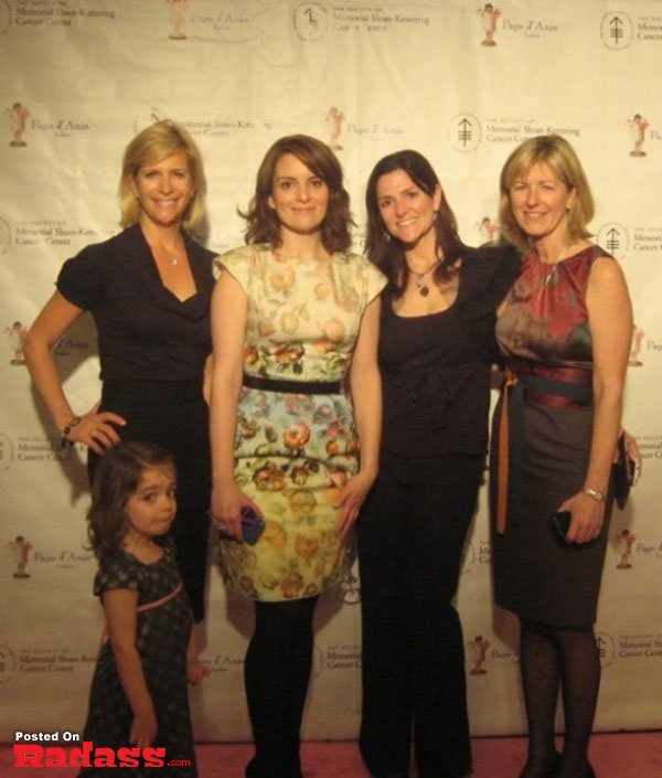A group of women photobombing a celebrity on a pink carpet.