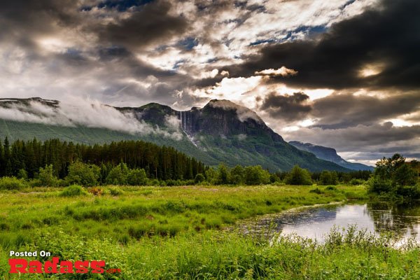 A mountain peak emerges from beneath a cloudy sky, offering an escape from civilization.