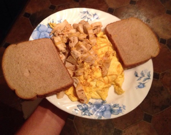 A college student is holding a plate of food.